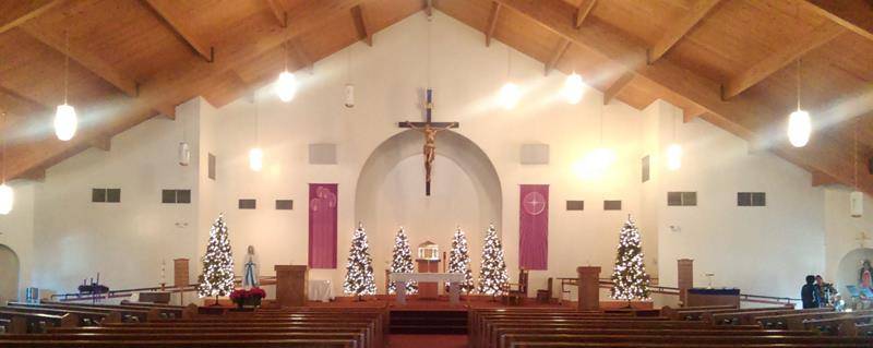 Our Lady of Lourdes Church in Monroe had blank white walls before artist Lisa Autry began a series of murals which now grace the front of the church. (Photo provided by Father Benjamin Roberts)