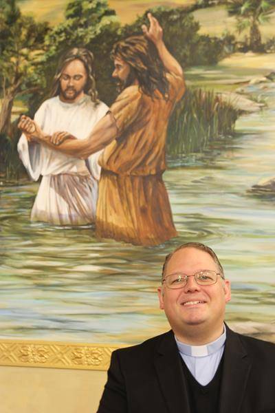 “See the waters that seem to overflow from the mural into our baptismal font.” 