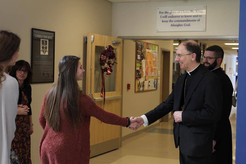 Bishop Peter Jugis greets students after the blessing of the new addition to CTKHS.