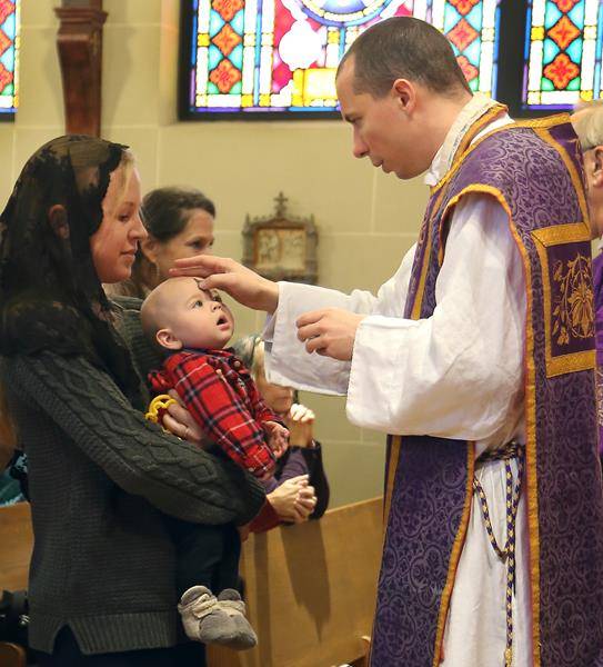 TRYON — On Ash Wednesday at St. John the Baptist Church in Tryon, ashes were distributed during Mass at 8:30 a.m., noon and 6:30 p.m. Father Jason Christian imposing the ashes to the youngest parishioner in attendance. (Giuliana Polinari Riley)