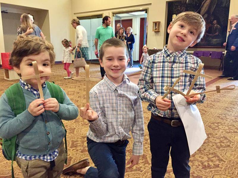 Children hold palms at St. Gabriel Church in Charlotte. 
