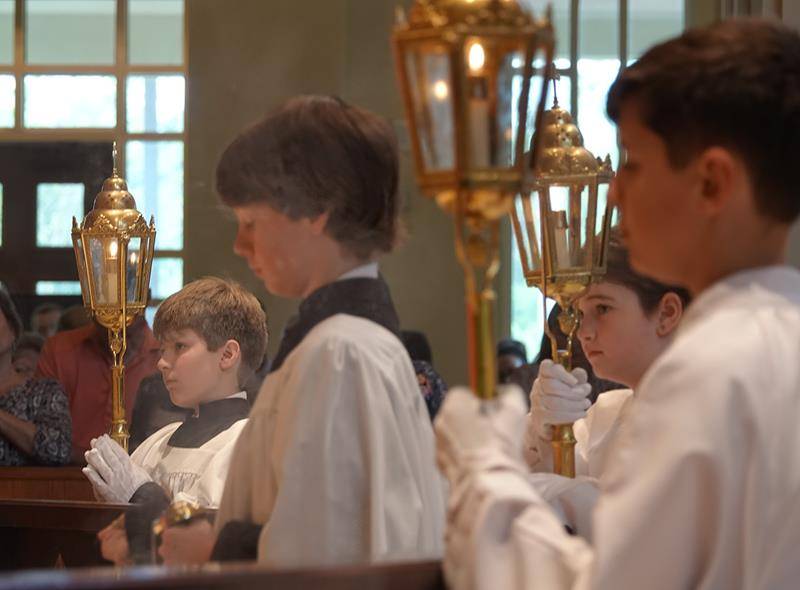 Altar servers are pictured during Palm Sunday Mass at St. Mark Church.