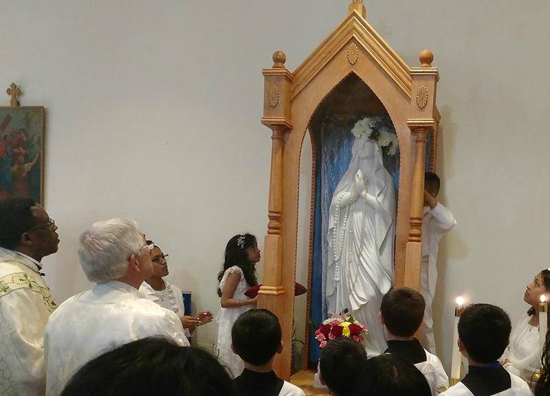 KING — First Communicants honored Mary with a May Crowning. (Photo via Facebook)