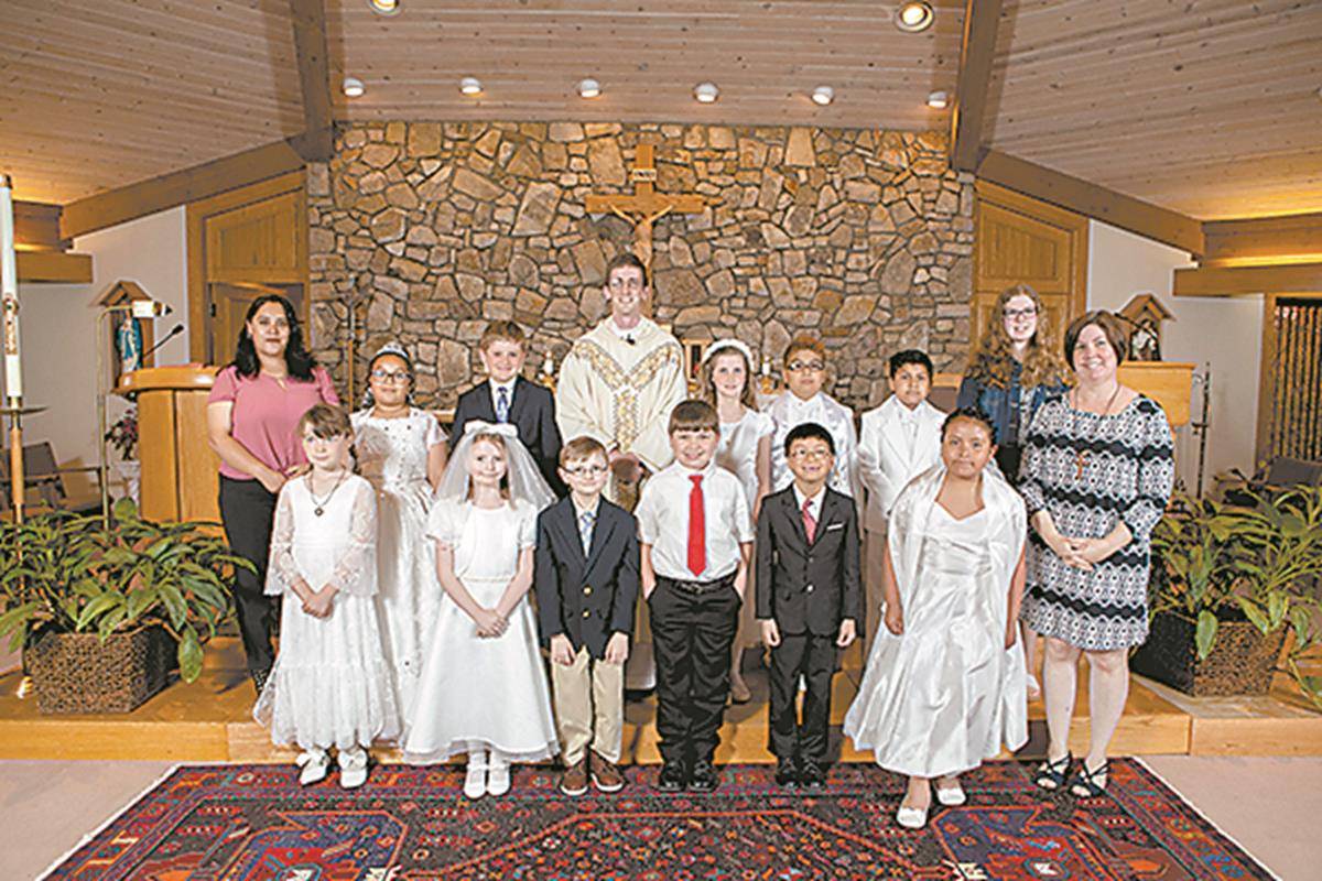 Children at St. Elizabeth Church in Boone received their first Holy Communion during a May 4 Mass celebrated by Father Matthew Codd, pastor. (Jean Moree and Amber Mellon | Catholic News Herald)
