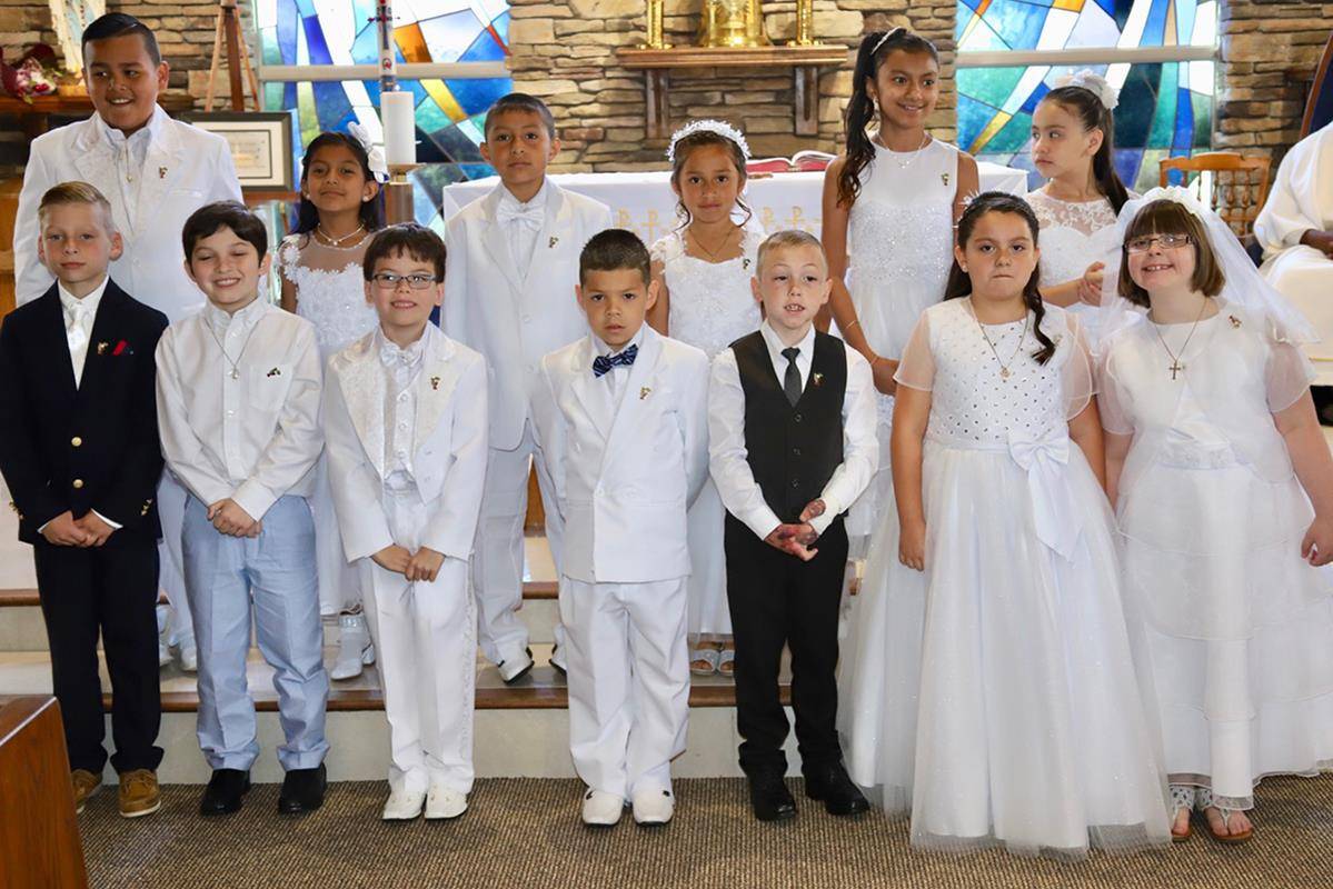 Children at Our Lady of the Rosary Church received their first Holy Communion during three Masses in May offered by Father Ambrose Akinwande, MSP, pastor. (Photos provided by Julia Fredrica Foy Michaels)