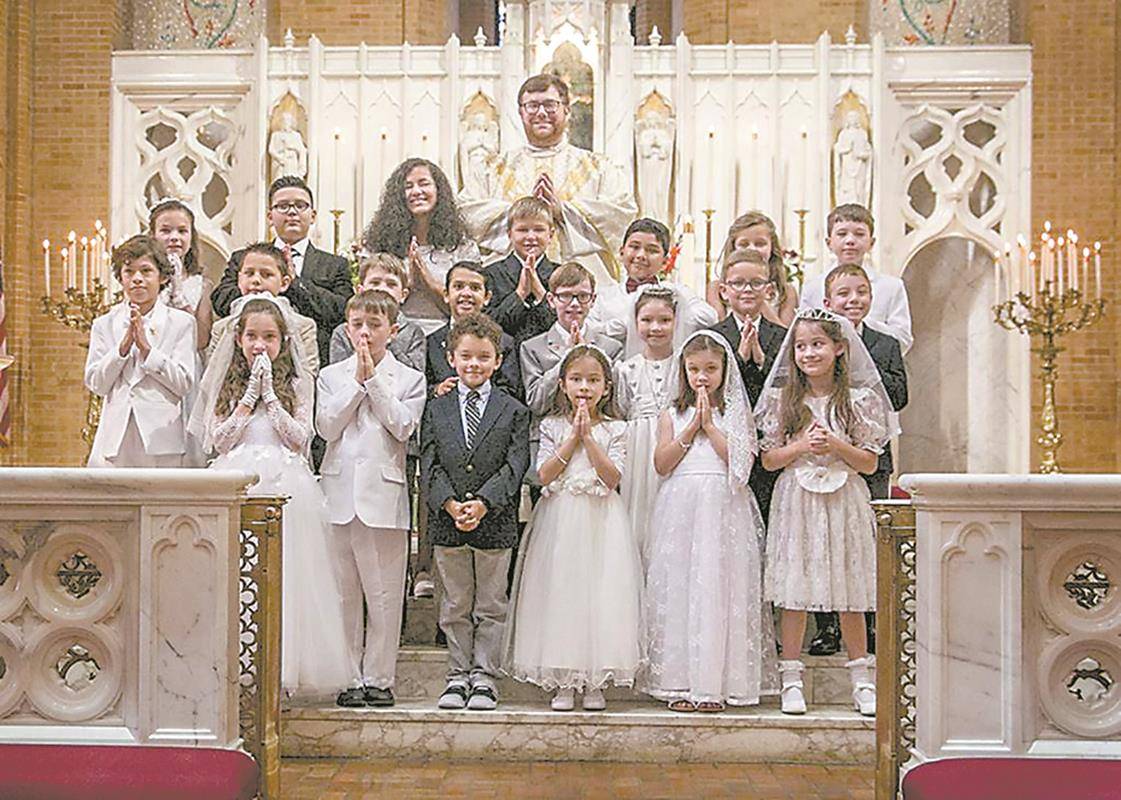 Children at Our Lady of Grace Church in Greensboro received their first Holy Communion during two Masses in May celebrated by Father Paul Buchanan, pastor, and Father Christian Cook, parochial vicar. (Photos by Melinda Stovall and Rachel Yarbrough)