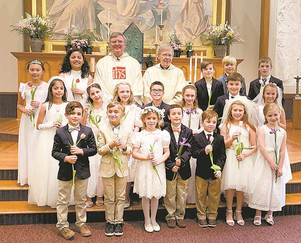 Children at St. Peter Church in Charlotte received their first Holy Communion during two Masses offered May 4 by Jesuit Father Jim Shea, pastor, and Jesuit Father John Michalowski, parochial vicar. (Photos provided by Cathy Chiappetta)
