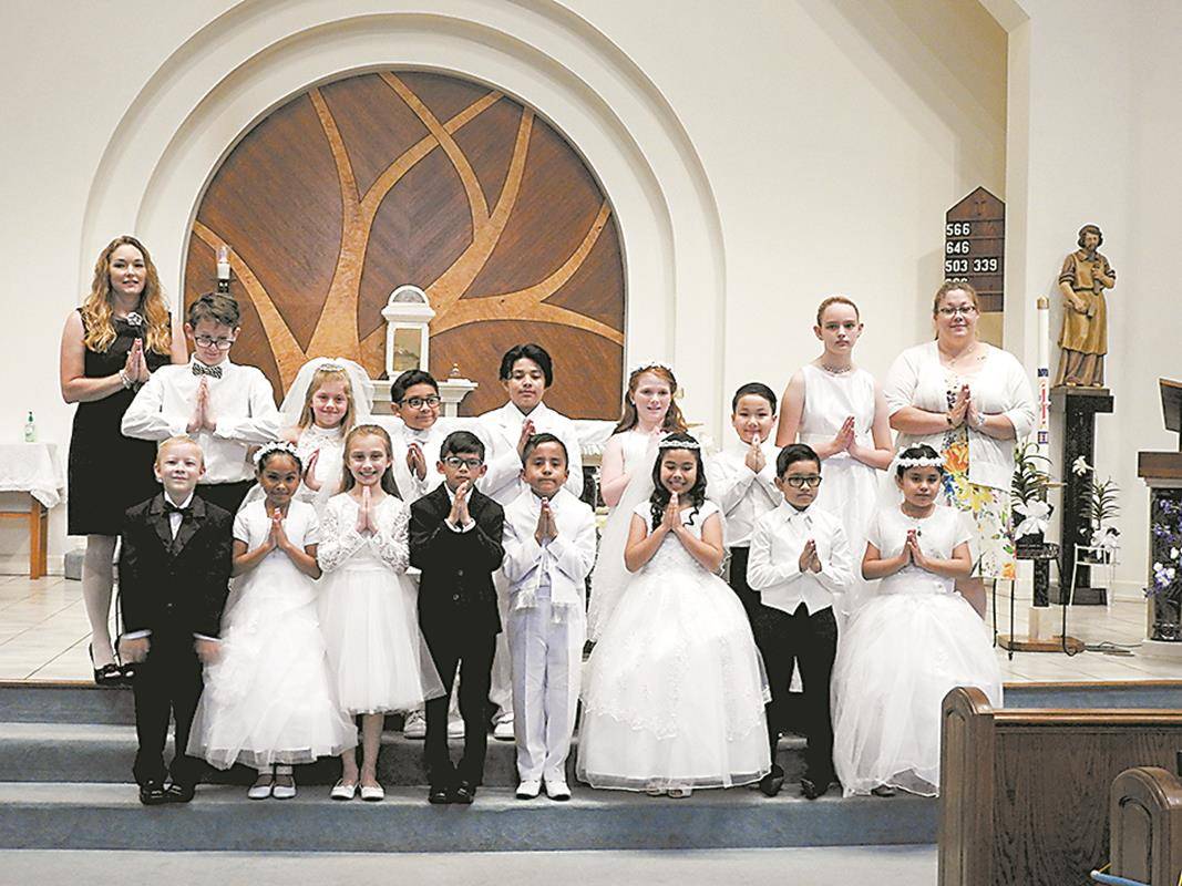 Fifty-five children and young adults received their first Holy Communion at St. Philip the Apostle Church in Statesville during two Masses celebrated May 5. (Photos provided by Connie Ries)