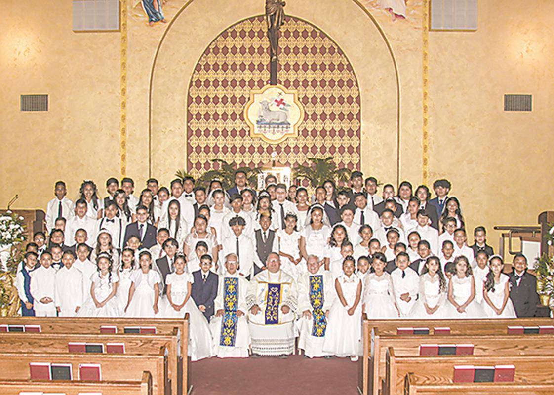 Many children received their first Holy Communion during two Masses celebrated by Father Benjamin Roberts, pastor, at Our Lady of Lourdes Church in Monroe May 4. (Photos provided by Ed Tepera)