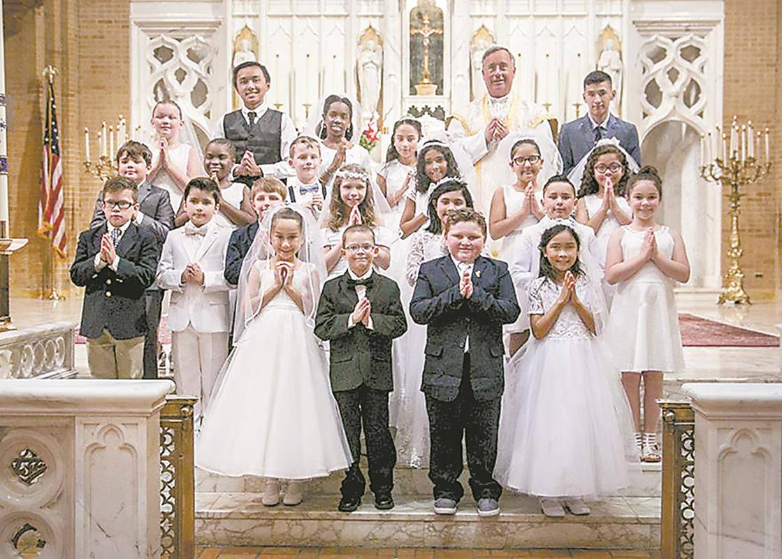 Children at Our Lady of Grace Church in Greensboro received their first Holy Communion during two Masses in May celebrated by Father Paul Buchanan, pastor, and Father Christian Cook, parochial vicar. (Photos by Melinda Stovall and Rachel Yarbrough)