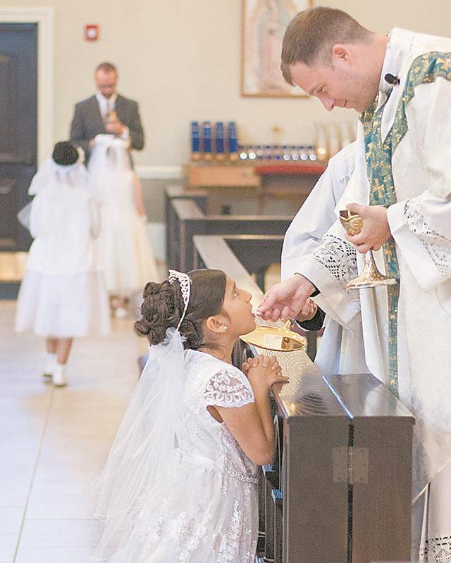 Children at Sacred Heart Church in Salisbury received their first Holy Communion during Mass offered by Father John Eckert, pastor, on May 4. (Bill Washington | Catholic News Herald)