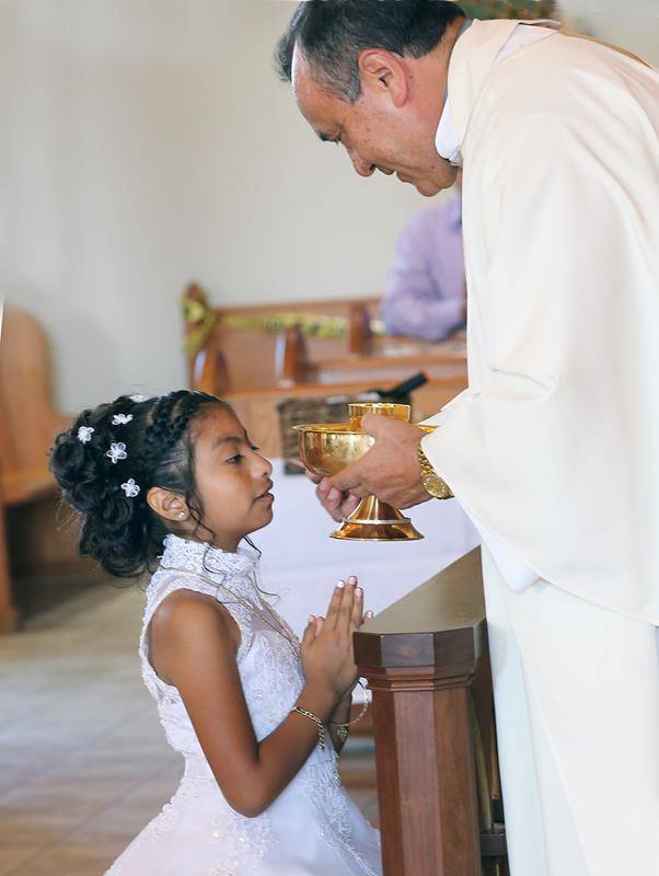 Seventeen children of the Hispanic community of Immaculate Conception Church in Forest City received first Holy Communion May 19 during a Spanish Mass concelebrated by Father Josè Antonio Juya and Father Herbert Burke. (Photos by Giuliana Polinari Riley)