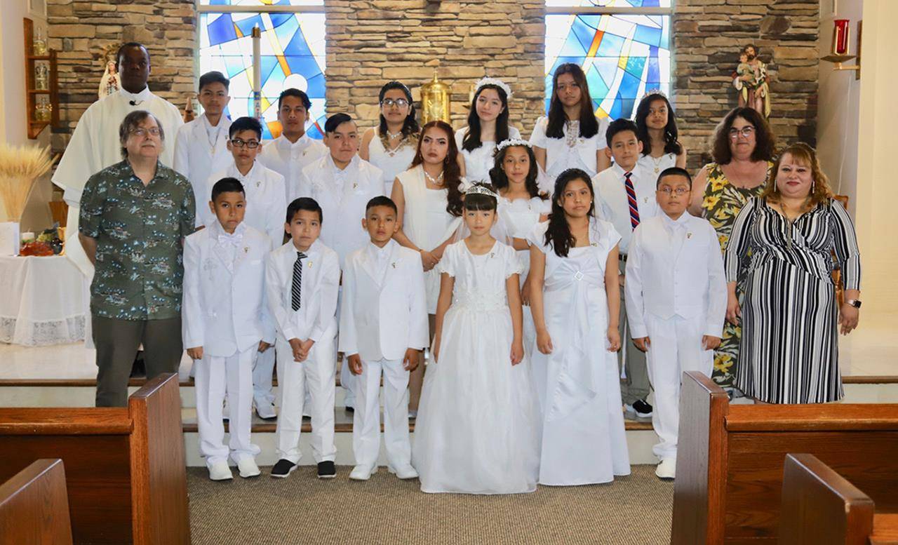 Children at Our Lady of the Rosary Church received their first Holy Communion during three Masses in May offered by Father Ambrose Akinwande, MSP, pastor. (Photos provided by Julia Fredrica Foy Michaels)