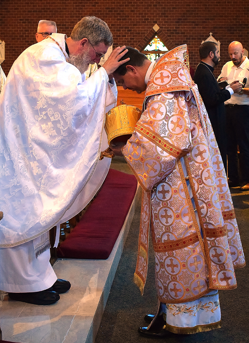 Newly-ordained Father Kevin gives his first blessing to Bishop Bohdan. (Della Sue Bryson)