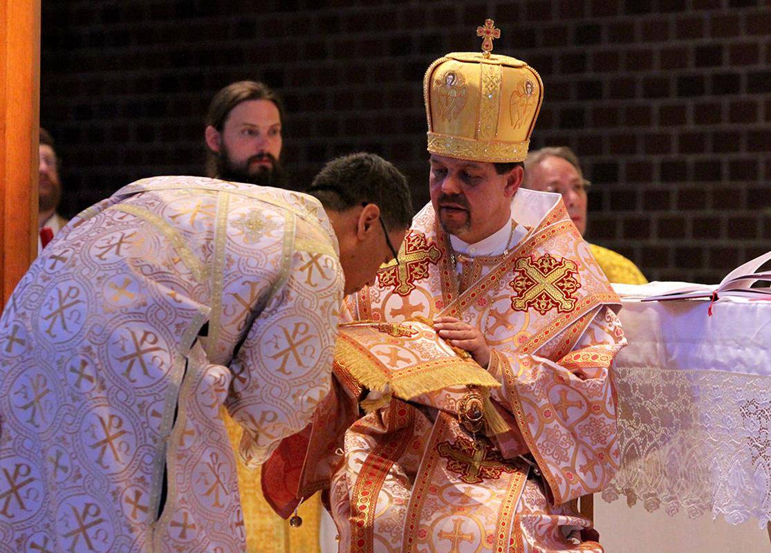 Basilius Magnus kisses the bishop's hand, his epigonation (part of the bishop's ceremonial vestments), and his right shoulder during the ordination rite.