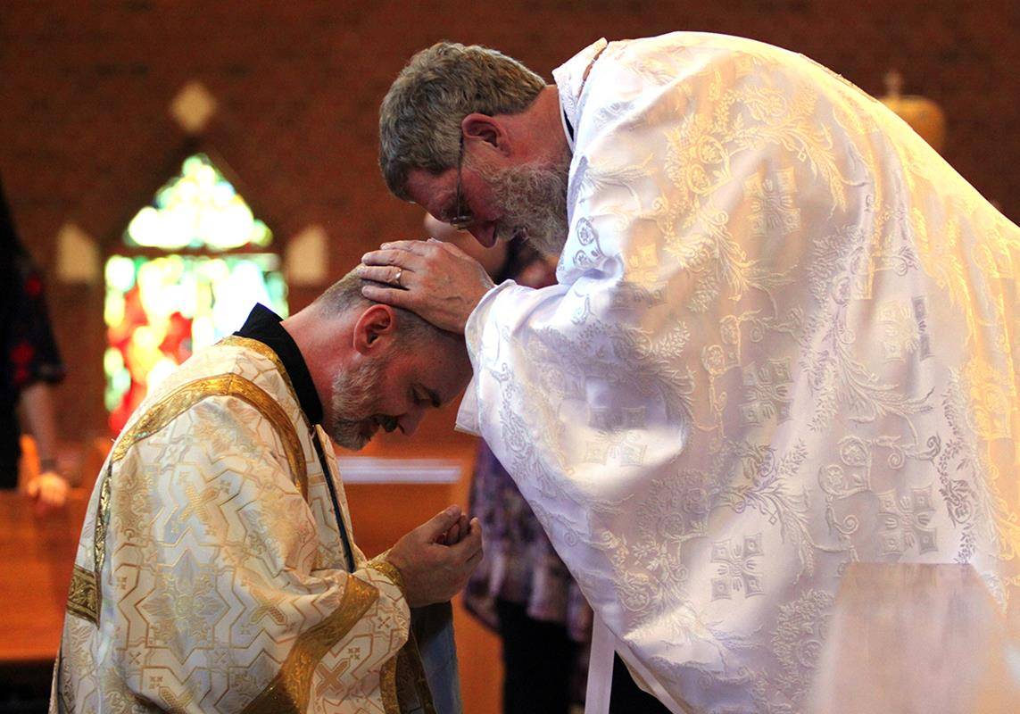 Father Kevin Bezner gives his first priest blessing to Deacon Matthew Hanes of St. Basil Church.