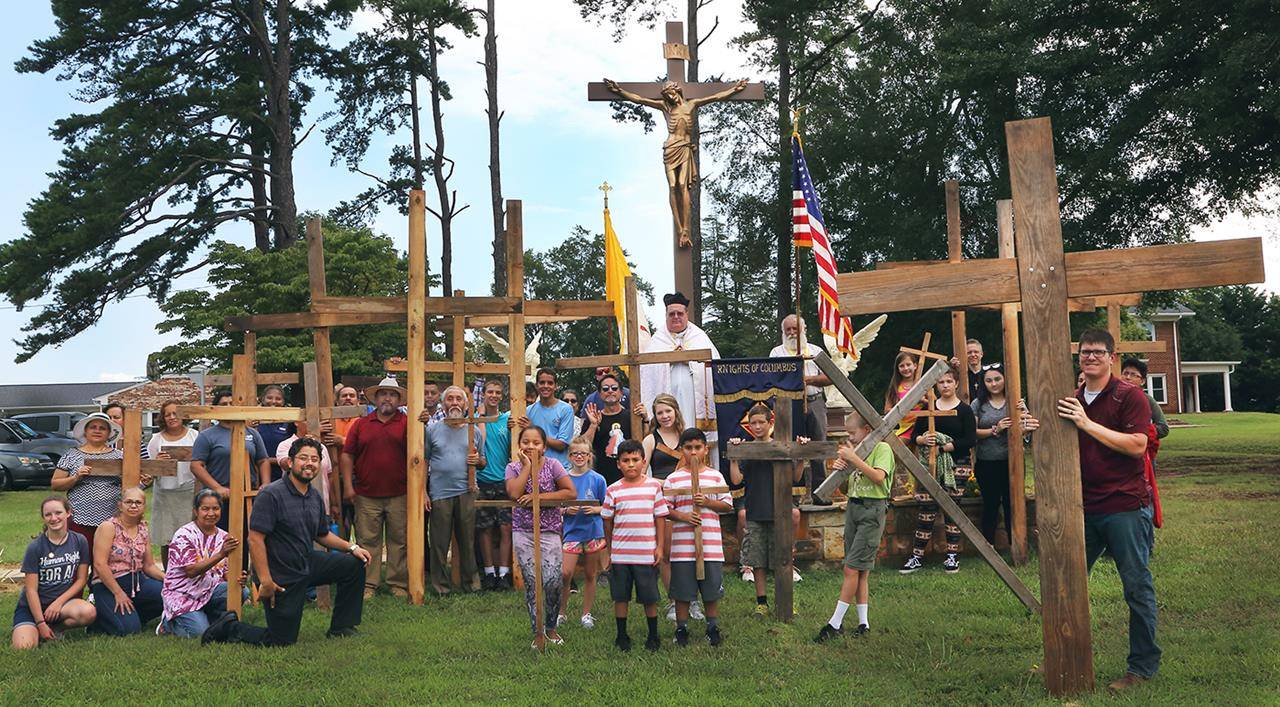 Cross-a-Thon walkers pose in front of crucifix.