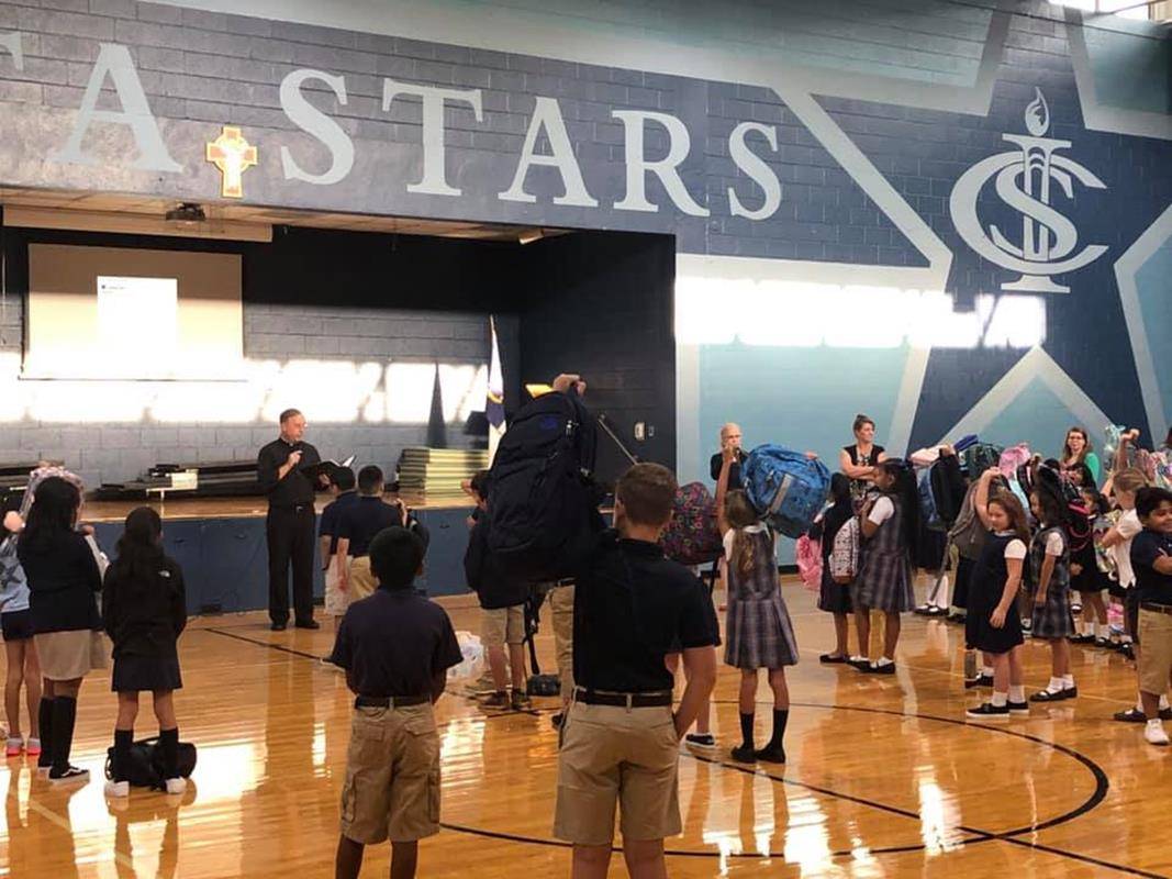 HENDERSONVILLE — Father Christian Cook performs the first annual Blessing of the Backpacks at Immaculate Conception School. (Photo via Facebook)