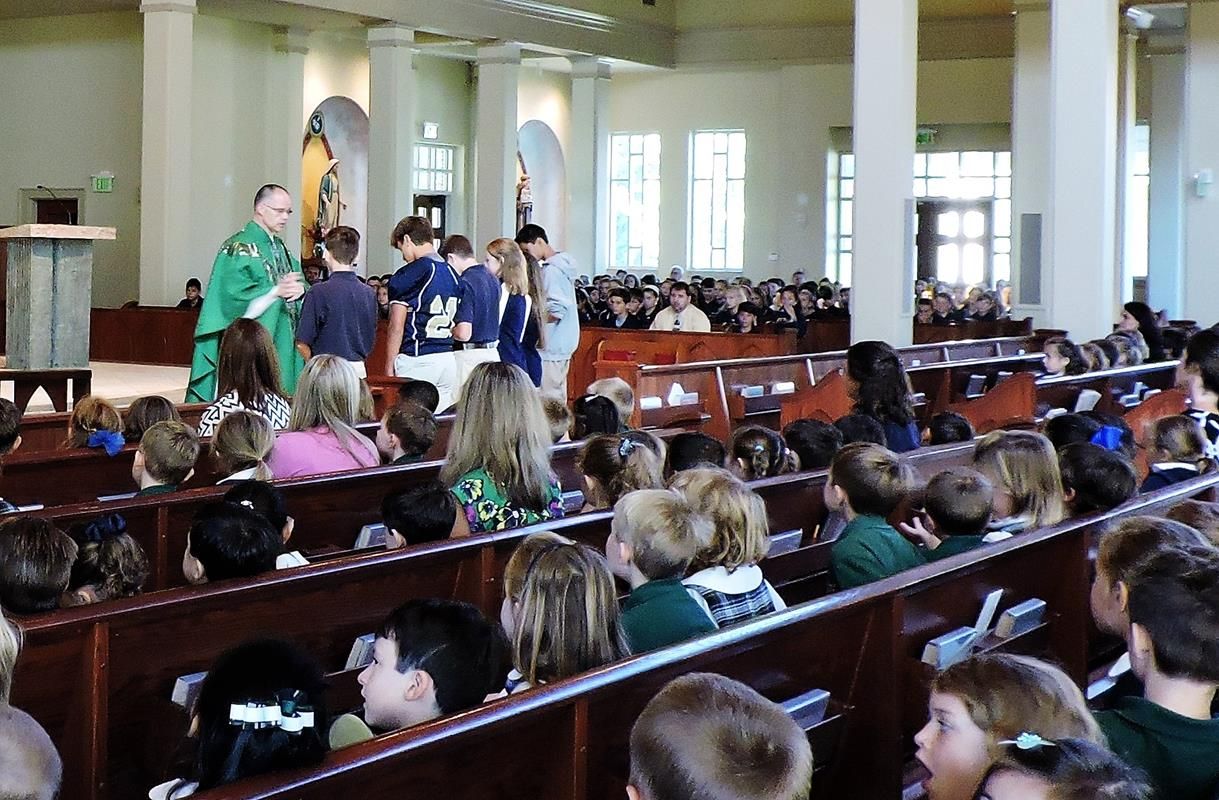 8th Graders receive a blessing after bringing the Gifts.