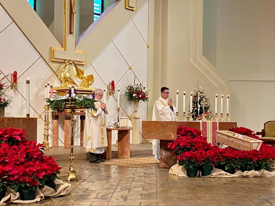 A scene from Christmas Mass offered by Father Richard Sutter, pastor, at St. Gabriel Church in Charlotte. (Photo via Facebook)