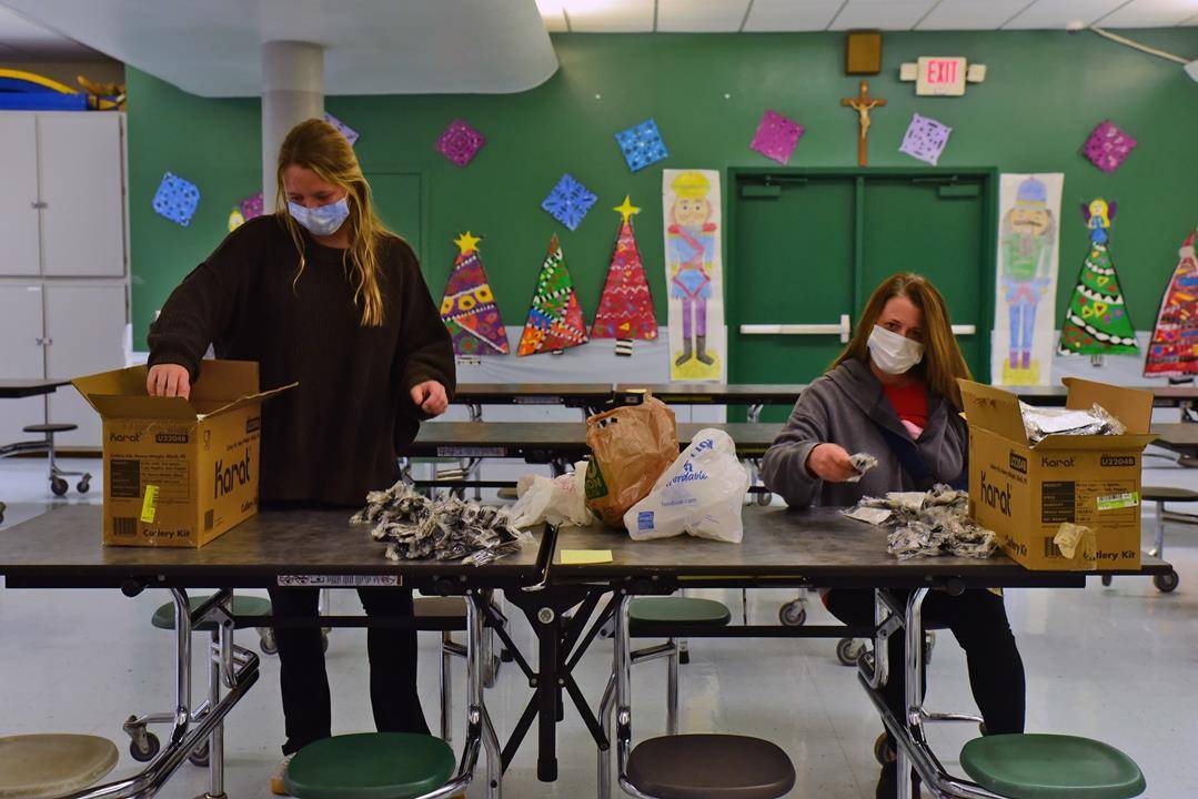 St. Patrick Cathedral in Charlotte continued its Christmas tradition of delivering meals to people in need around the Charlotte area. Entrees were prepared by Waiter’s Choice Catering, and parish volunteers packaged meals for delivery. Photo via Facebook