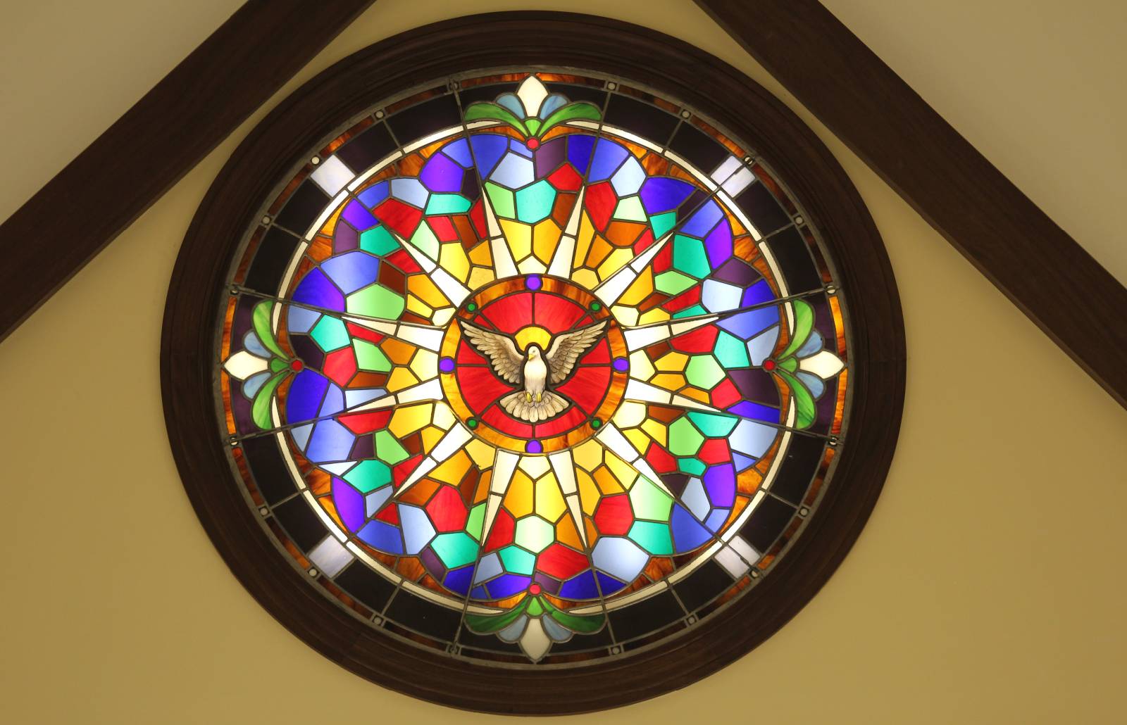 Above the sanctuary in the new Holy Family Chapel in Clemmons is a vibrantly colored Holy Spirit window which is visible to all who sit in the nave of the chapel.