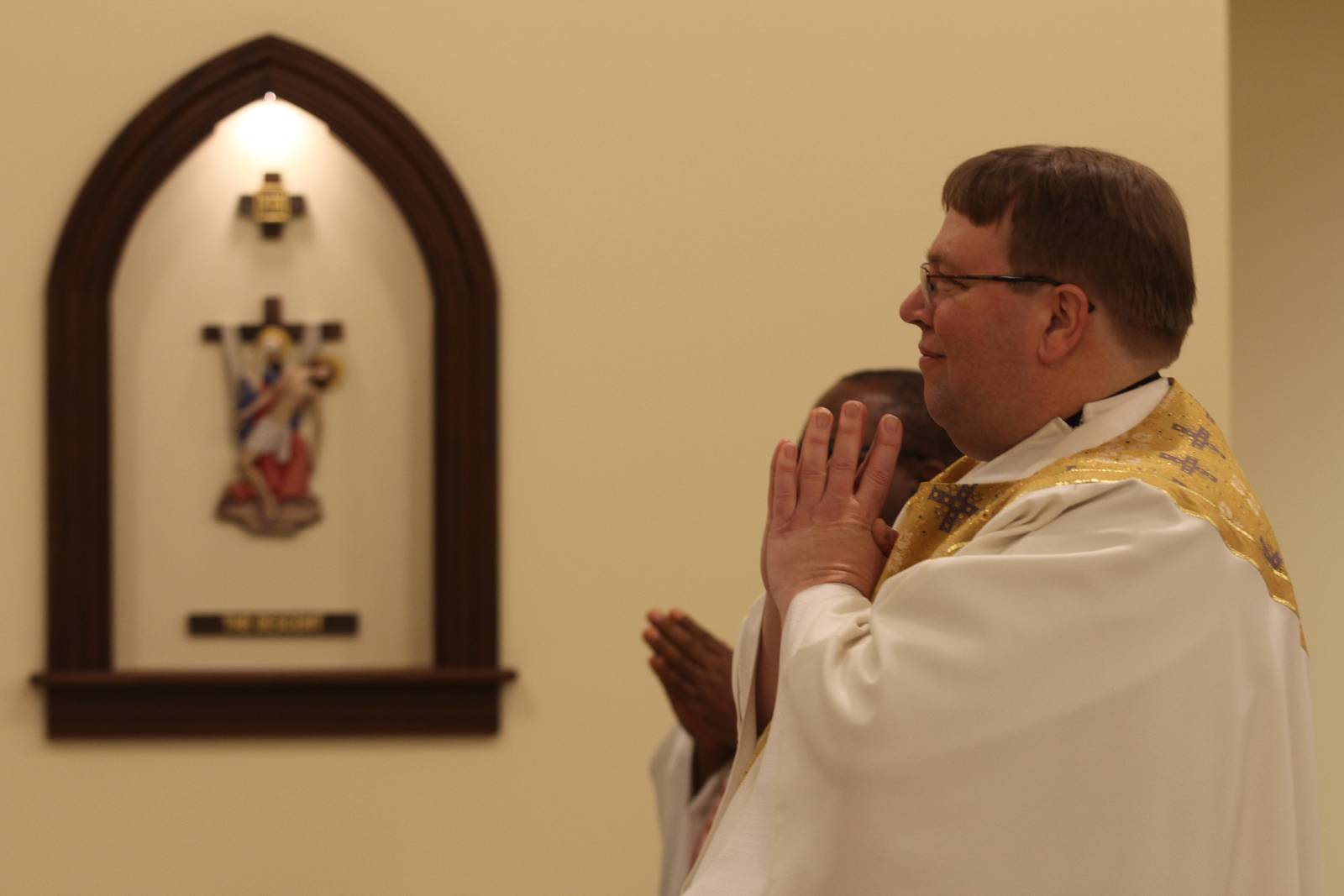 Father James Stuhrenberg, pastor of Holy Family Church, smiles as Bishop Jugis begins blessing the new chapel on Jan. 27.