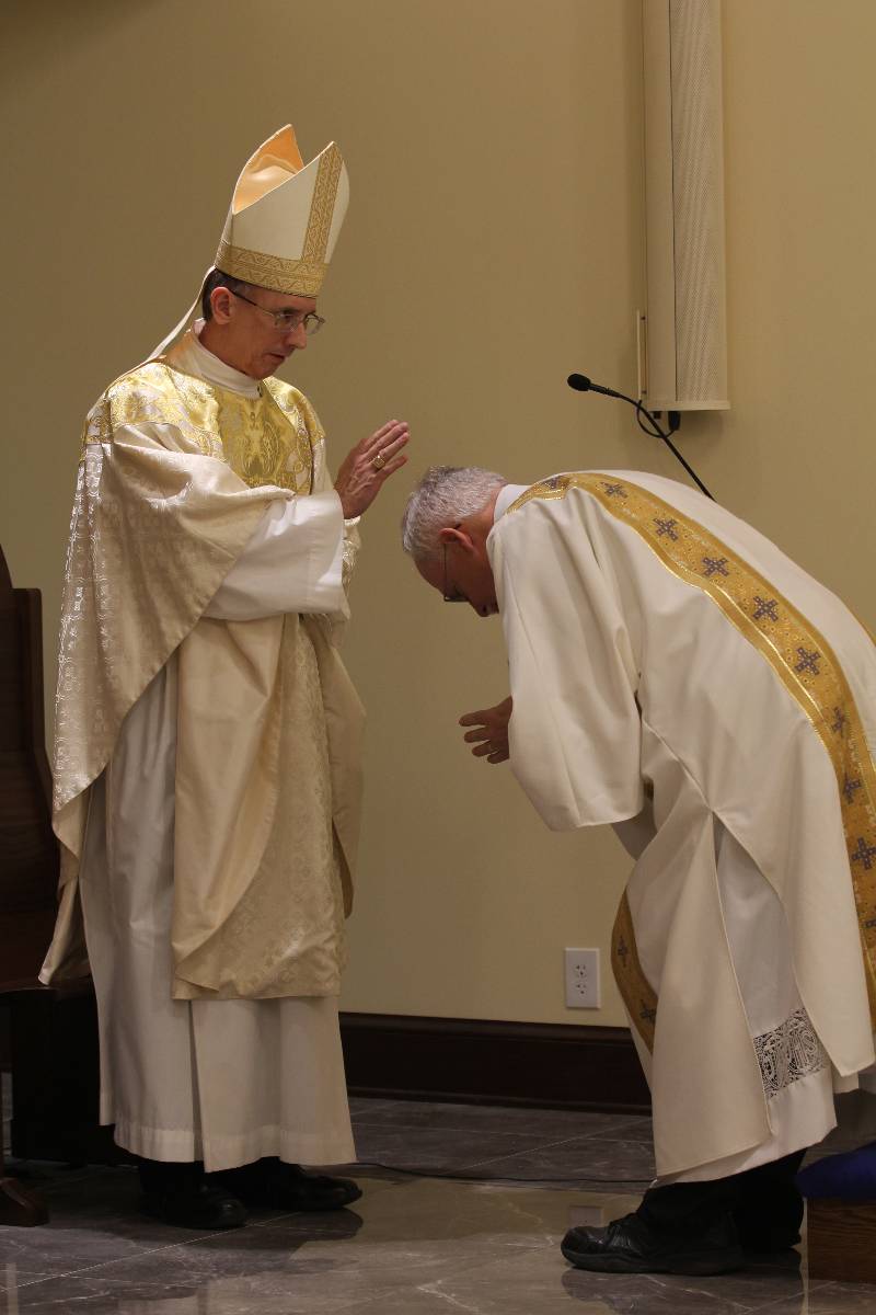 Bishop Peter Jugis gives Deacon John Harrison a blessing before he reads the Gospel at Mass in the Holy Family Chapel Jan. 27.