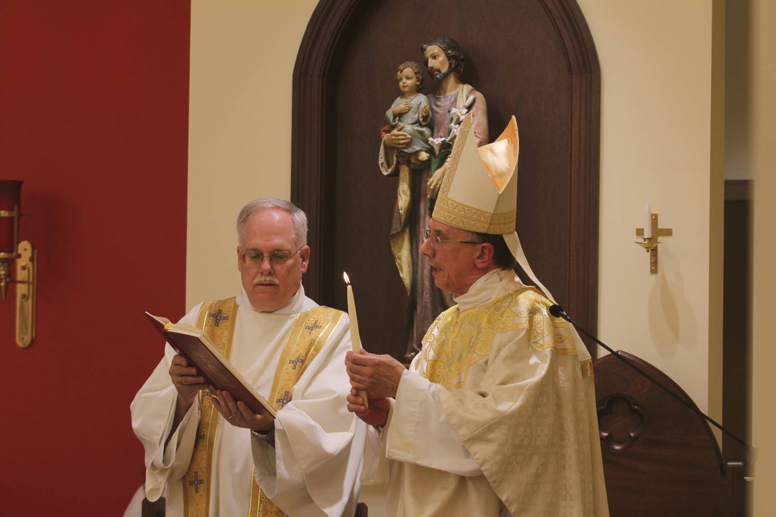 Bishop Peter Jugis prays before the altar candles are lit for the first time in the new Holy Family Chapel in Clemmons Jan. 27.
