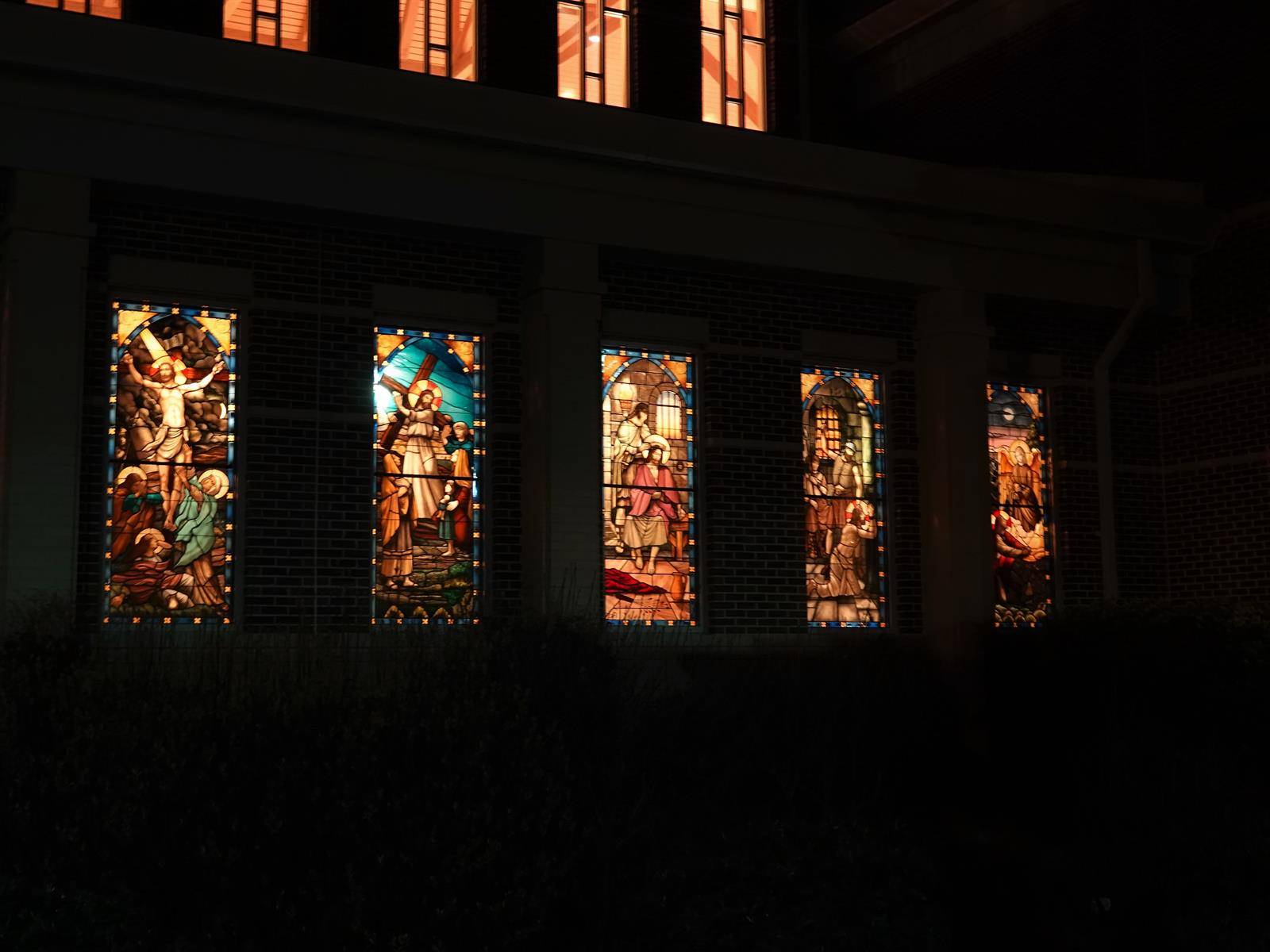 St. Mark stained glass windows lit up at night.
