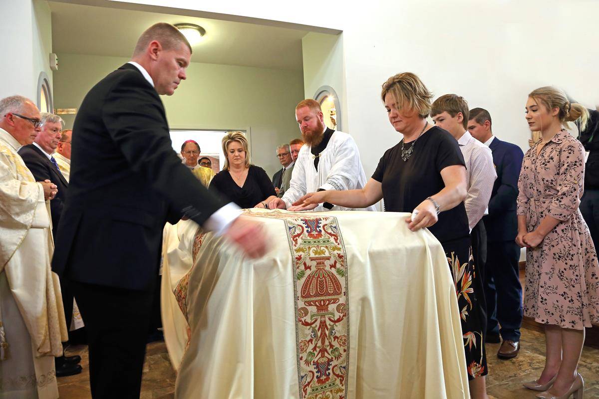The pall is draped over Father Kottar's casket as the body is received before the start of Mass.
