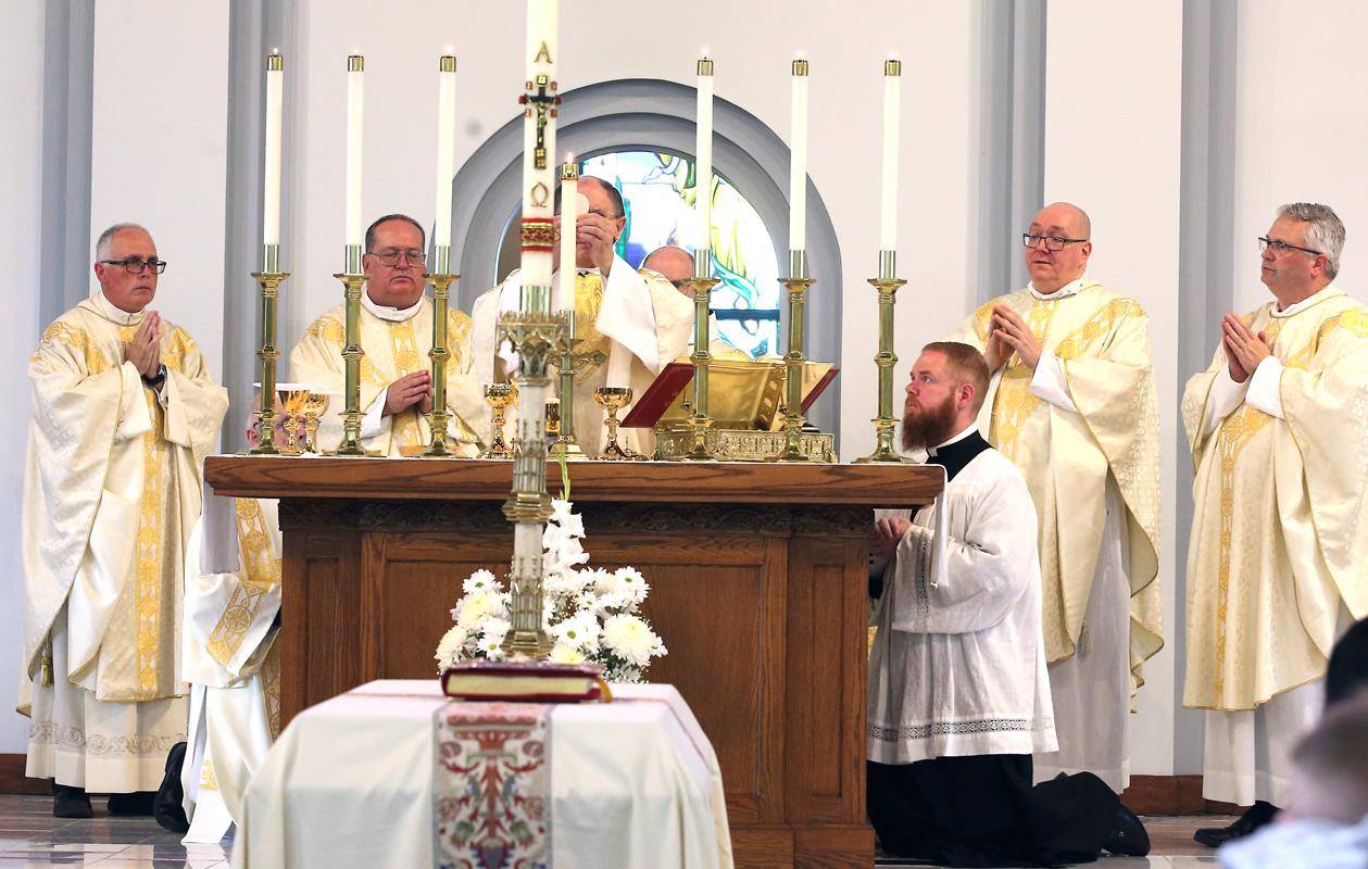 Bishop Peter Jugis celebrated the funeral Mass. Atop Father Kottar's casket lay a crucifix and Book of the Gospels.