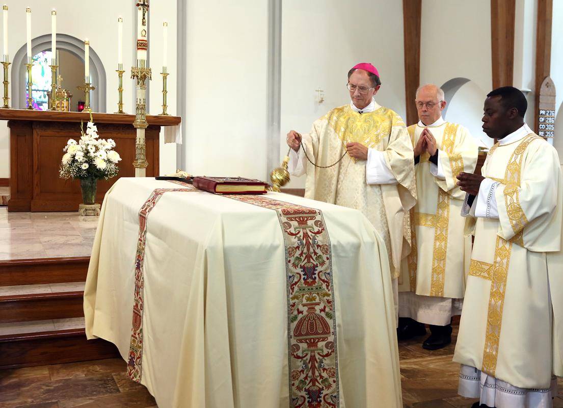 Bishop Jugis censes the casket during the final commendation.