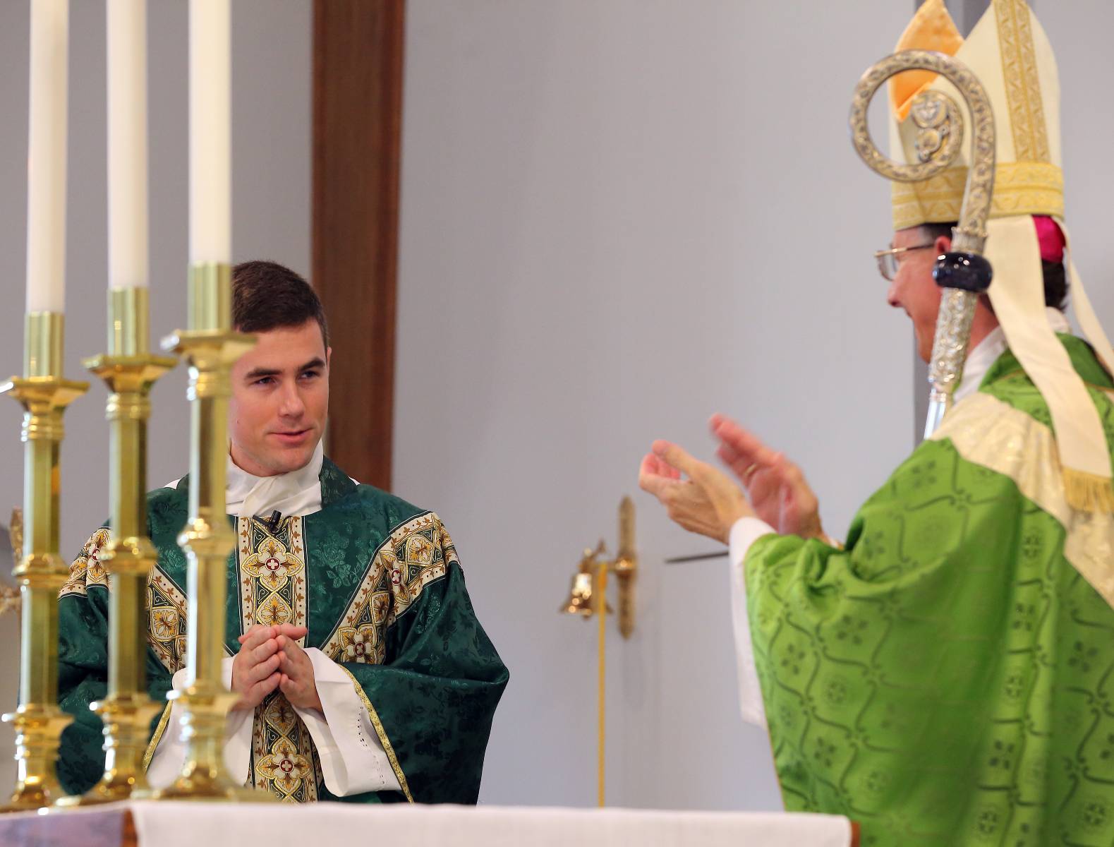 Bishop Jugis congratulates newly installed Father Ascik.