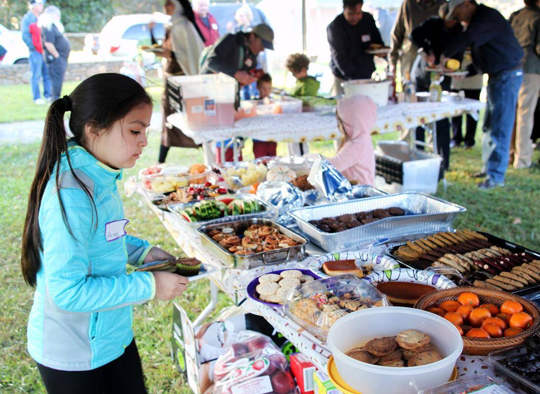 Young parishioners warily eye the roast pig – apple in his mouth – featured on the buffet table. 