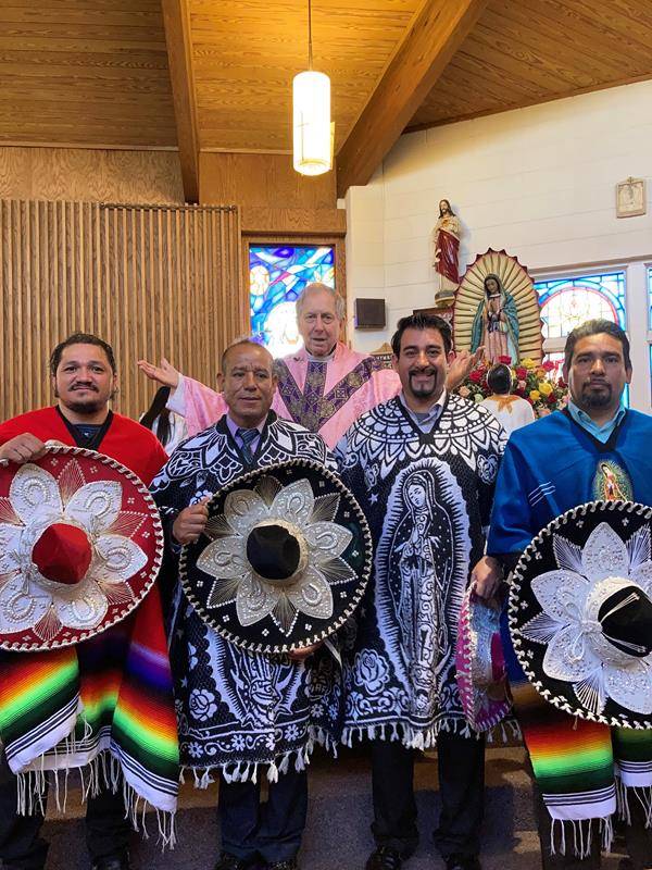 Members of Our Lady of the Angels Mission, pictured with pastor Father Carl Kaltreider, celebrate the Feast of our Lady of Guadalupe in Marion Dec. 12. (Photo provided by Alfonso Alvarez-Navarrete)