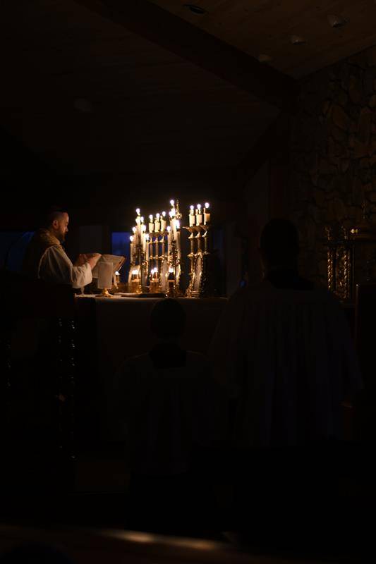 Father Brendan Buckler, pastor of St. Elizabeth Church in Boone, prays during the Rorate Mass Dec. 11. (Photo provided by Amber Mellon)