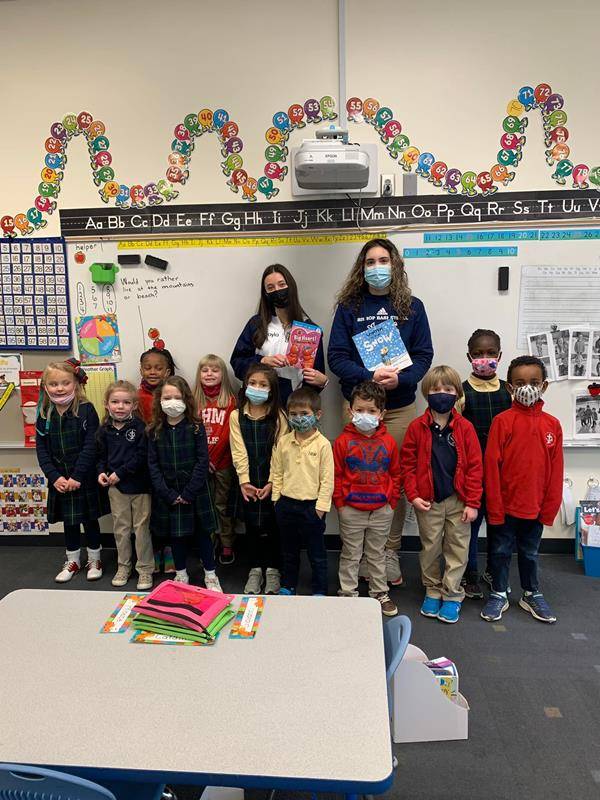Bishop McGuinnes High School students and alumni read to younger students