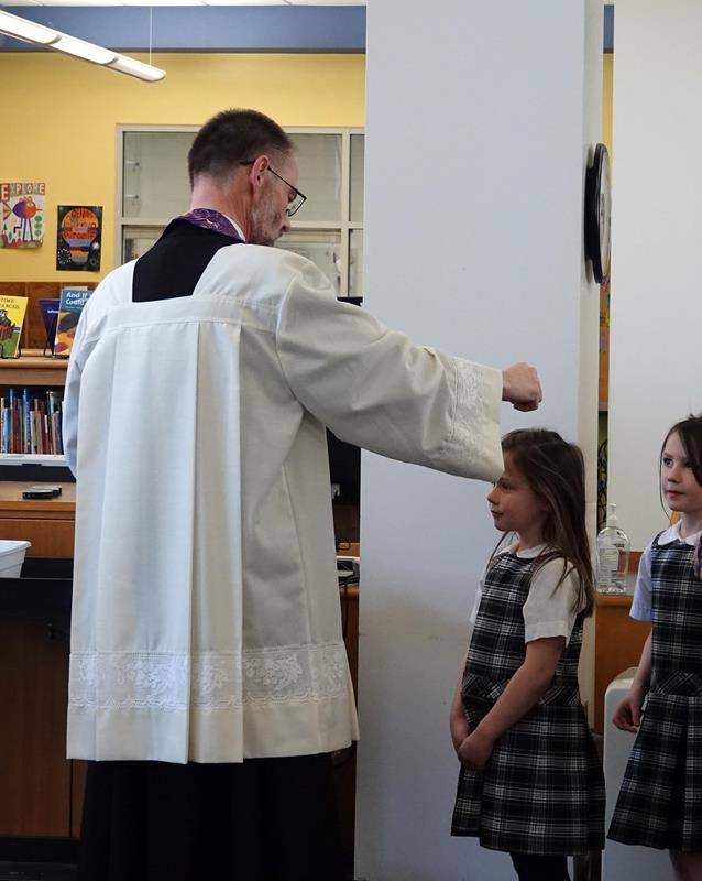 St. Mark School kindergarten through second grade attended a Liturgy of the Word and Distribution of Ashes in the school library. Father John Putnam was the celebrant.  (Photo provided by Amy Burger)