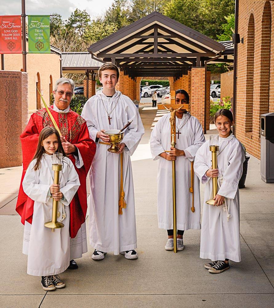 Father Mark Lawlor and altar servers after Palm Sunday Mass at St. Therese Church in Mooresville. (Photo by Dan Callaghan) 