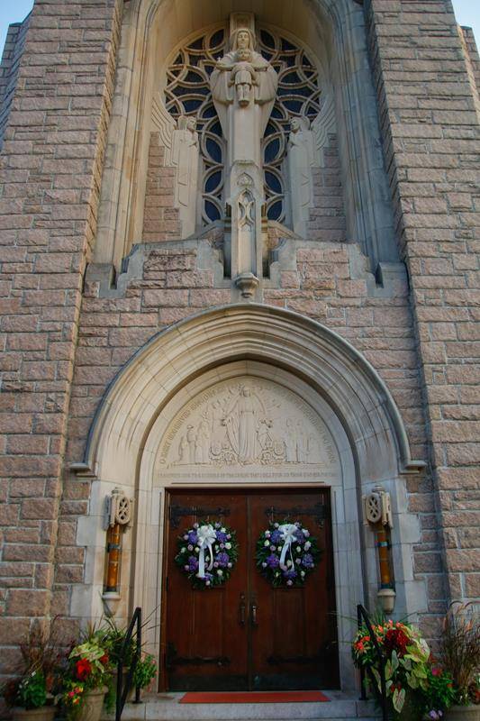 The Market Street entrance of the church features a beautiful stone statue of Our Lady and the Infant Jesus as well as an intricate carving of Our Lady of the Miraculous Medal.