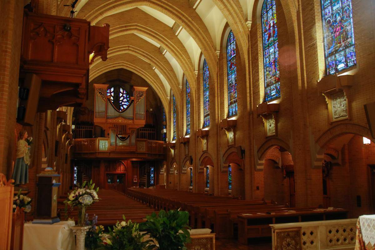 The church is breathtaking at twilight. A statue of St. Maria Goretti (left) commemorates the veneration of her major relics at Our Lady of Grace in 2015.