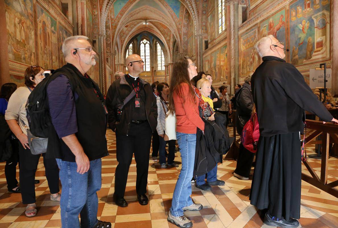 Polgrims admire frescos in the Upper Church of San Francis in Assisi
