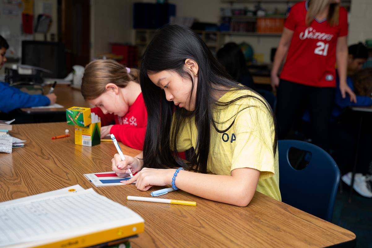 Students at Our Lady of the Assumption School make cards to send to veterans during Catholic Schools Week. 