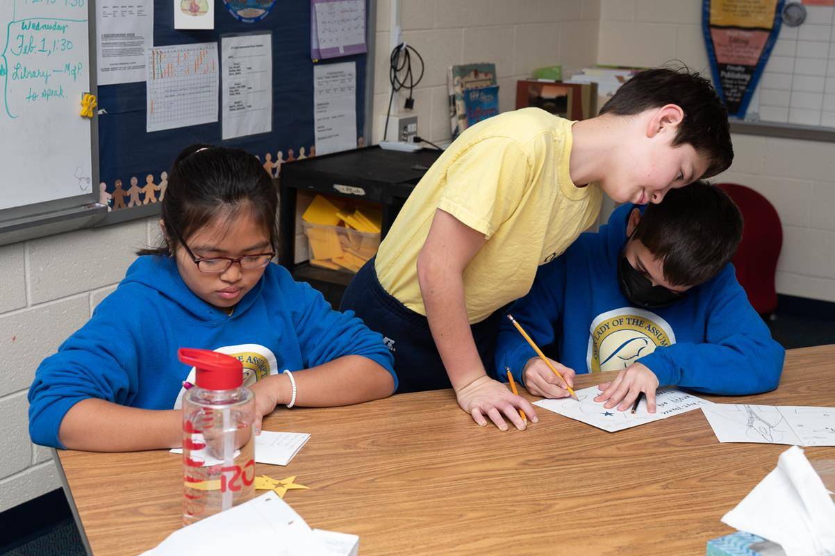 Students at Our Lady of the Assumption School make cards to send to veterans during Catholic Schools Week. 