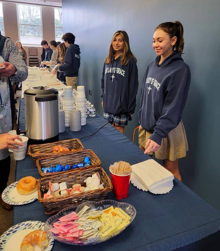 Students at Our Lady of Grace School hand out treats after Mass to start Catholic Schools Week.