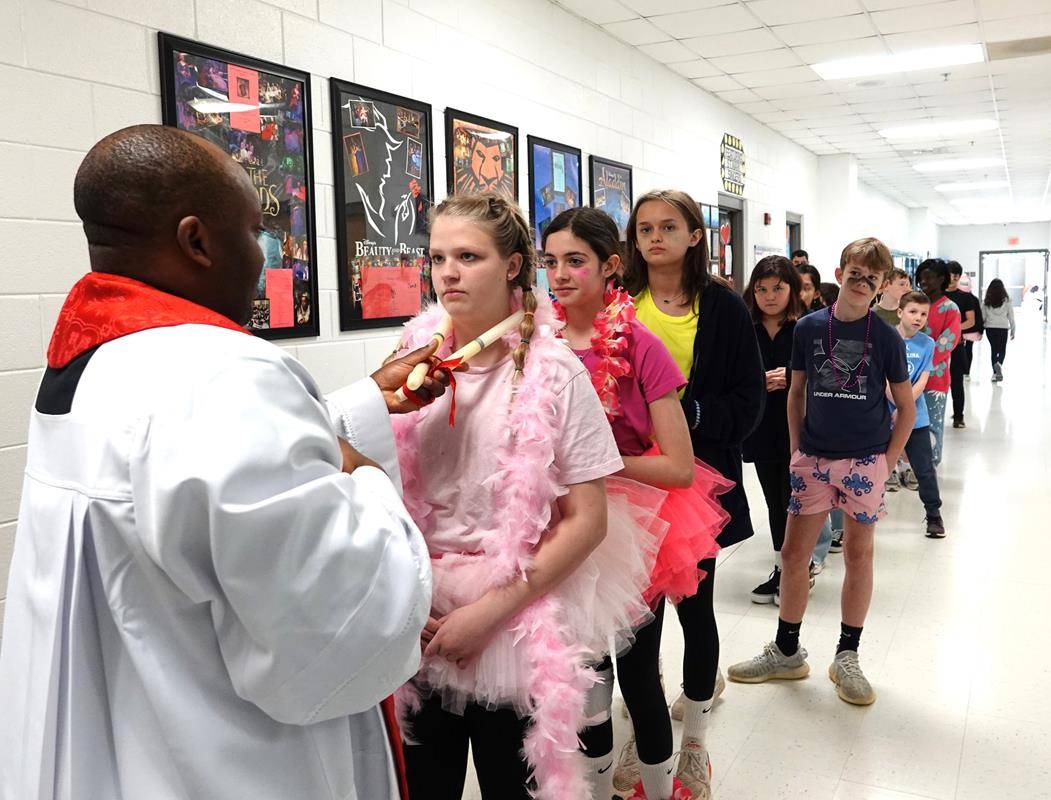 The middle school students were on their way to the annual Catholic Schools Week student volleyball games when they dress in team costumes—a great image of the intersection of faith and fun at Catholic schools in the diocese.