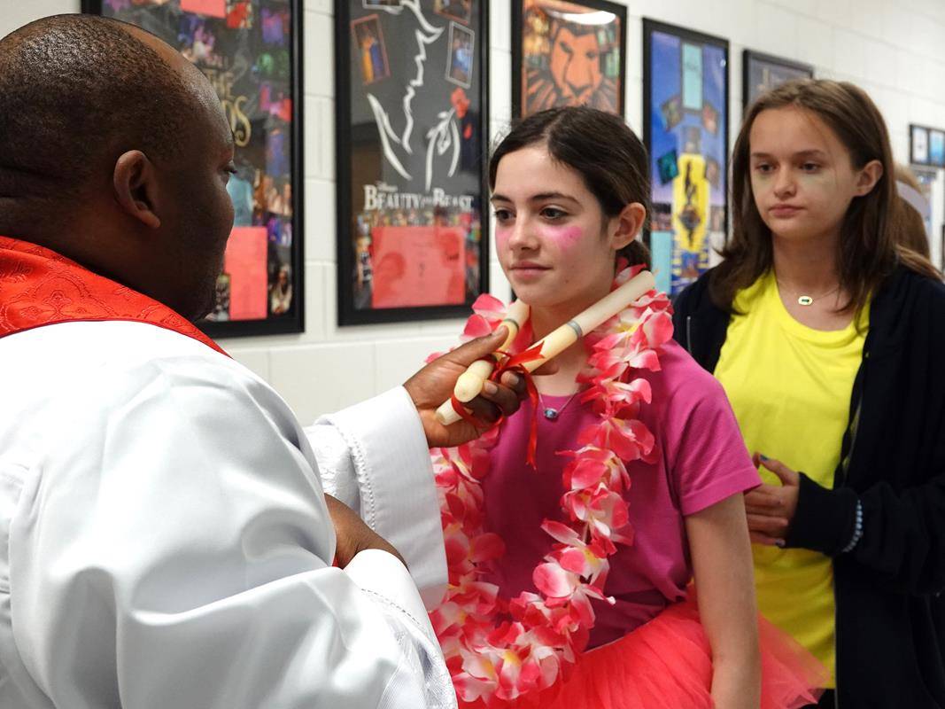 The middle school students were on their way to the annual Catholic Schools Week student volleyball games when they dress in team costumes—a great image of the intersection of faith and fun at Catholic schools in the diocese.