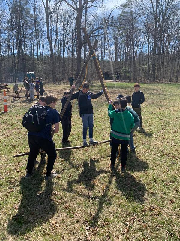 Scouts carry another Scout on the Trinity Triangle they constructed, to test its strength and durability. (Photo by Rob Stallings)