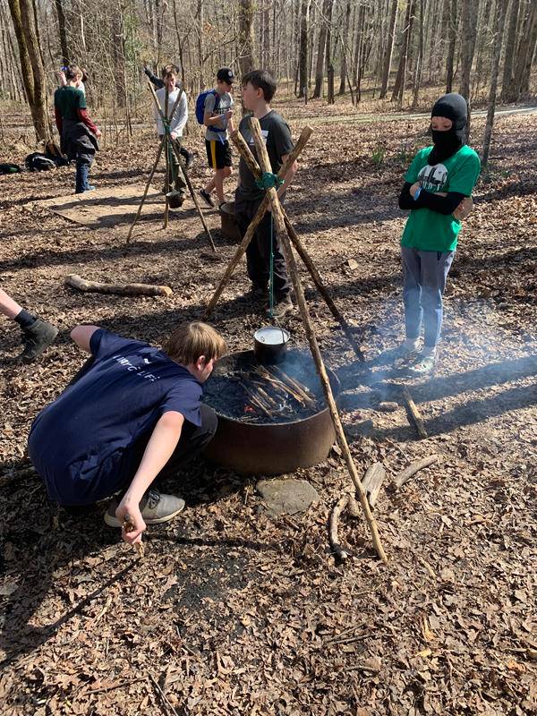 Scouts make a campfire tripod. (Photo by Rob Stallings)